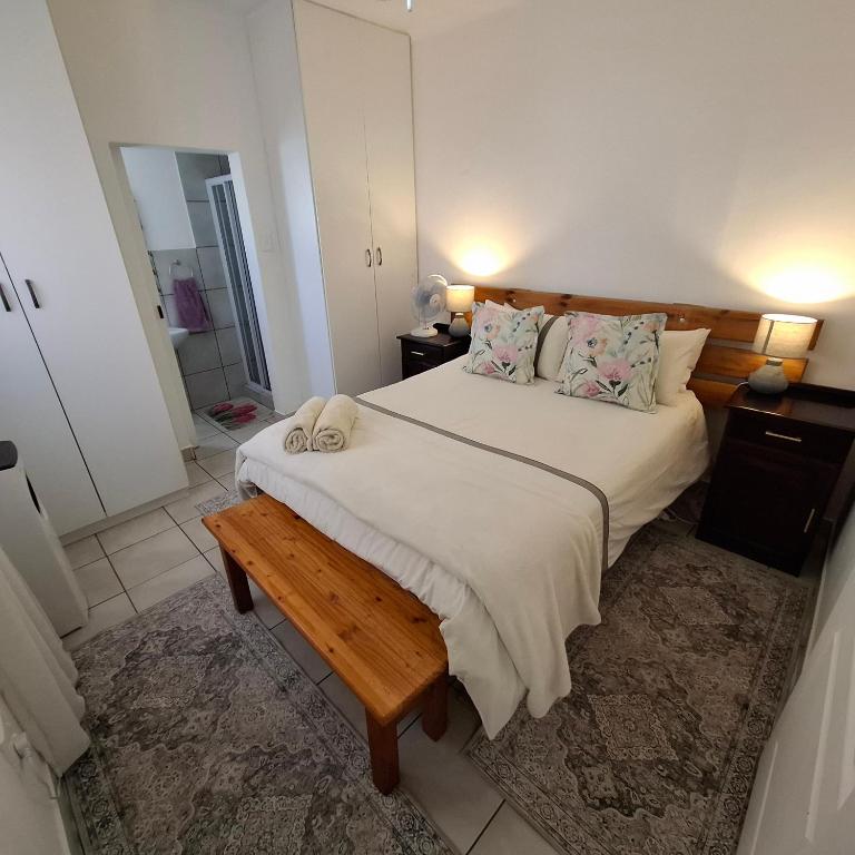 a bedroom with a large bed with a wooden headboard at Albert's Nest in Kimberley