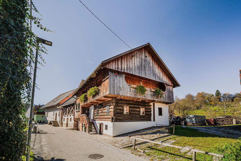 a wooden building with plants on the side of it at Traditional Slovenian House Pr'Belej in Zgornje Gorje