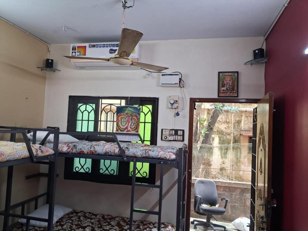 a room with three bunk beds and a window at MSVNATIVE HOME Stay Near Airport in Chennai