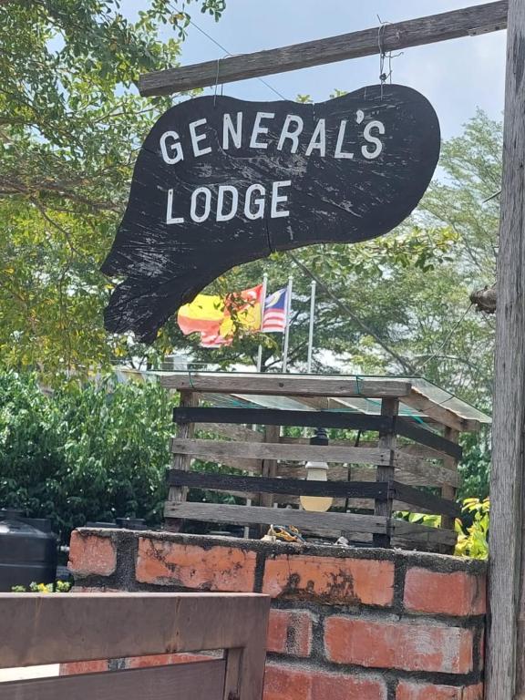 a sign for a gemaniles lodge with a flag at General's Lodge Staycation in Kampong Sungai Sembilang