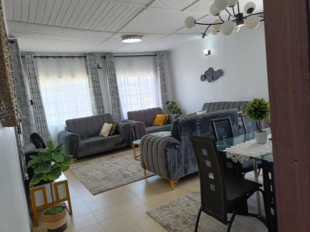 a living room with two couches and a table at Greenstar villa homes in Kisii