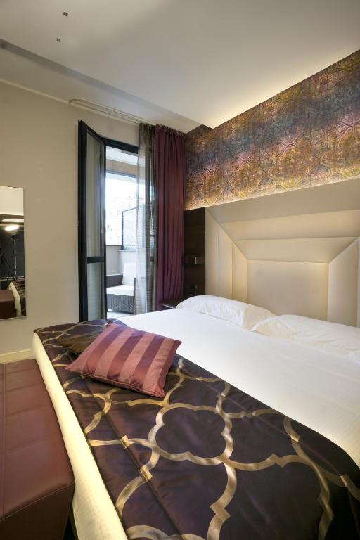 Postel nebo postele na pokoji v ubytování Hotel Soperga
