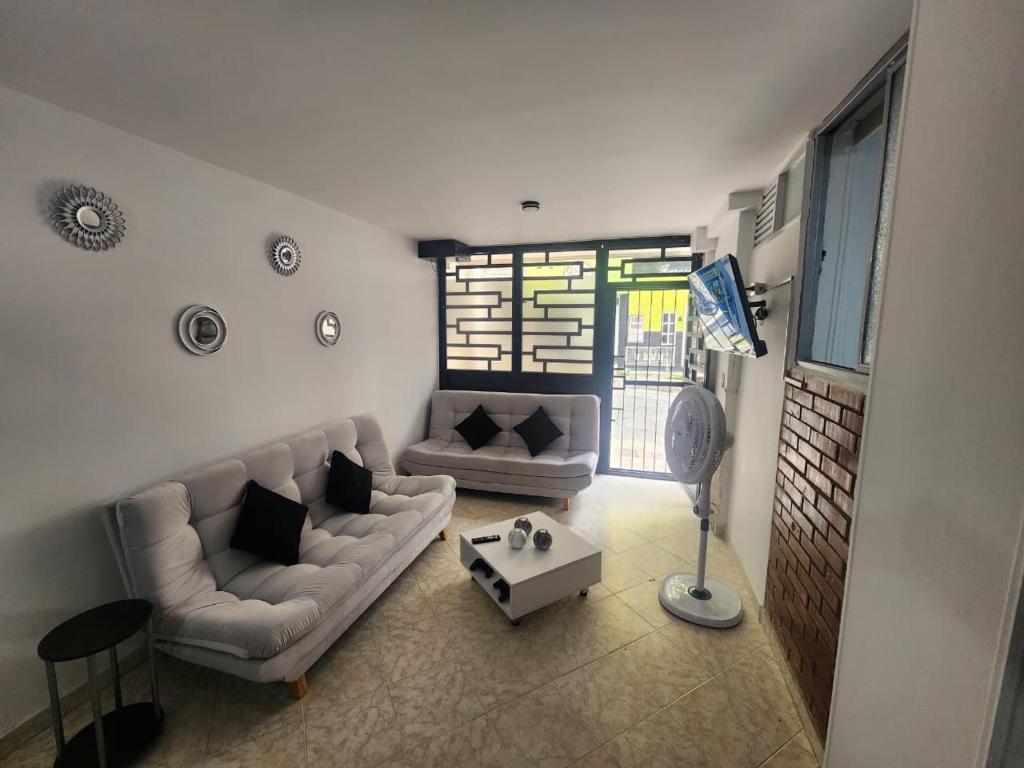 a living room with a couch and a table at Apto a pasos del CC Delacuesta in Piedecuesta