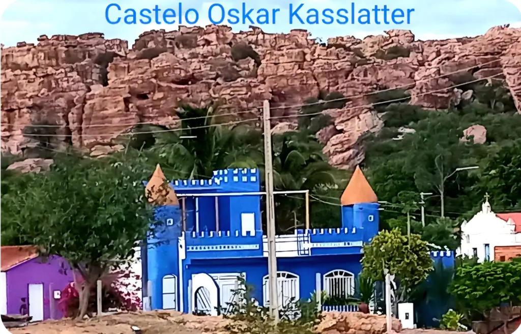 a blue building in front of a mountain at Um castelo só pra você! 