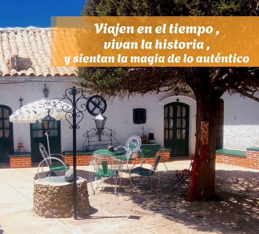 een huis met een tafel en stoelen en een boom bij Casa María Victoria 