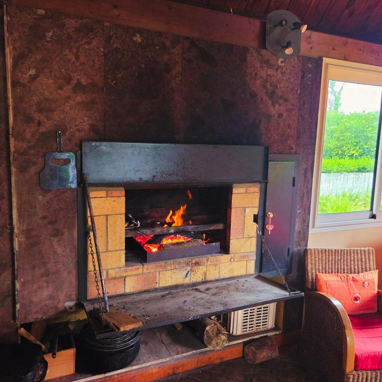 a fireplace in a living room with a fire at Bienvenue chez Gaston in Le Tampon
