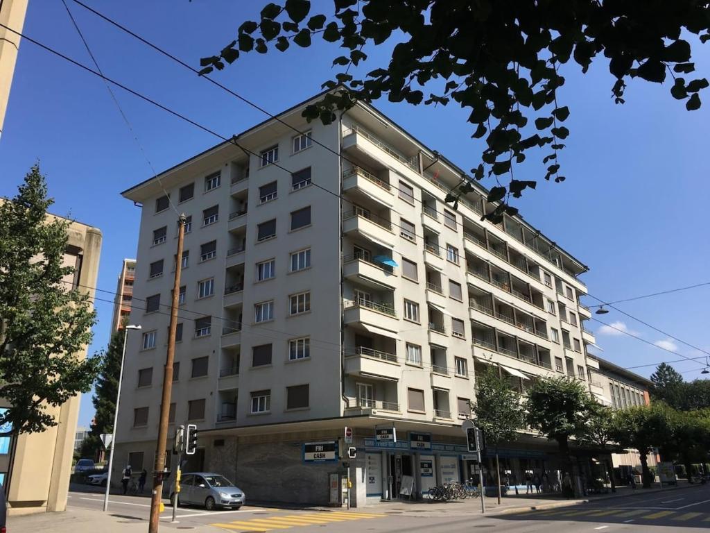 a large white building on a city street at Private Ideal Apartment in Fribourg