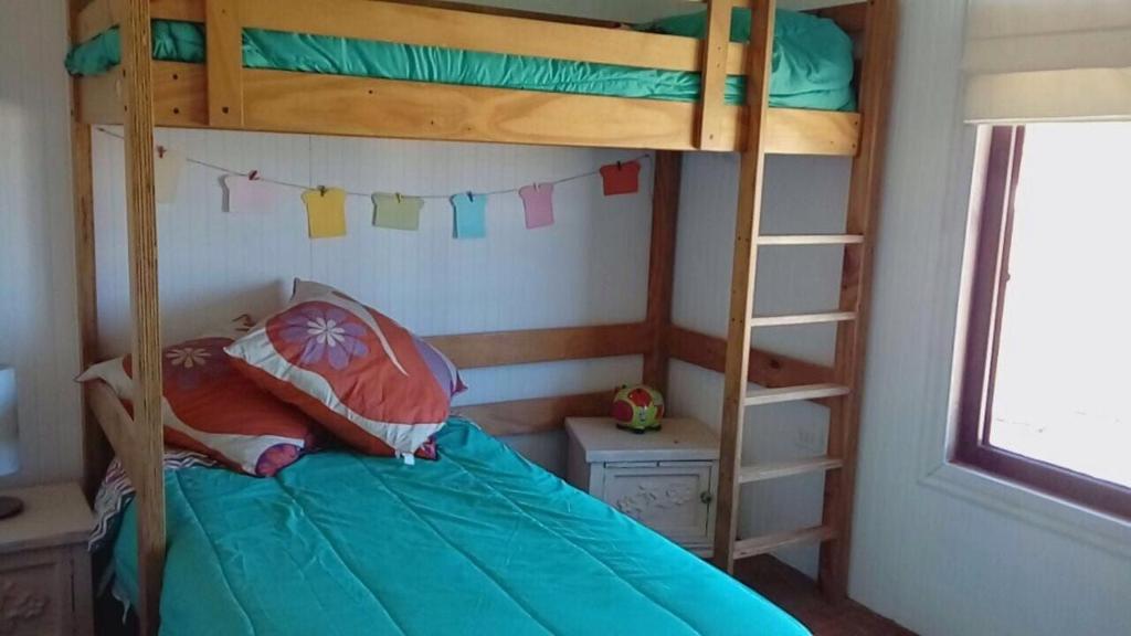 En eller flere senge i et værelse på Casa Lago Rapel Punta del Sol