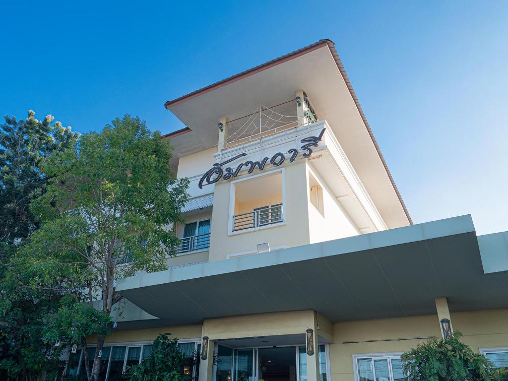 a building with a sign on the side of it at Amphawaree Hotel in Samut Songkhram