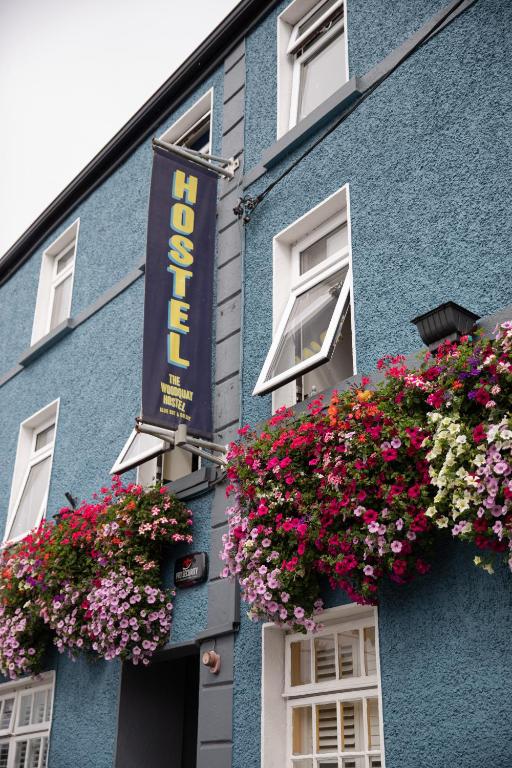 a blue building with flowers on the side of it at The Woodquay Hostel in Galway