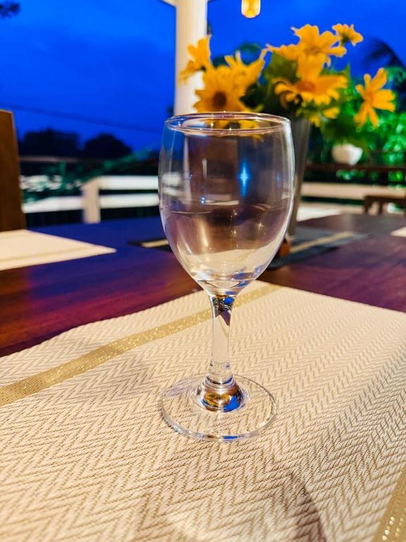 a wine glass sitting on top of a table at Sunset Villa in Dickwella