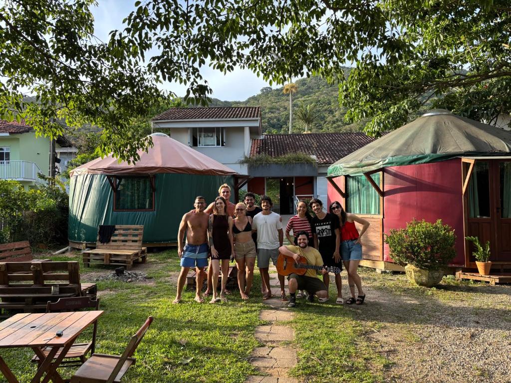 a group of people posing for a picture in a yard at Nômades Vibe da Ilha - Adventure Hostels in Florianópolis