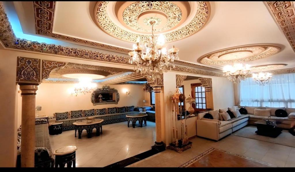a large living room with a chandelier at 3 bedroom Nijma large authentic Moroccan apartment in Tangier