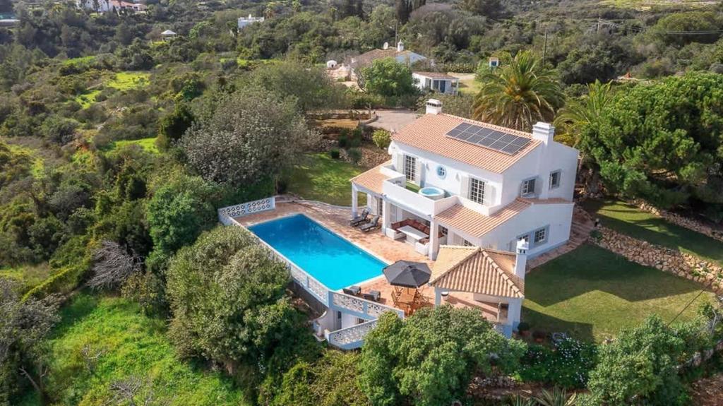 an aerial view of a house with a swimming pool at Spacious Villa Swimming Pool by HostWise in Lagoa