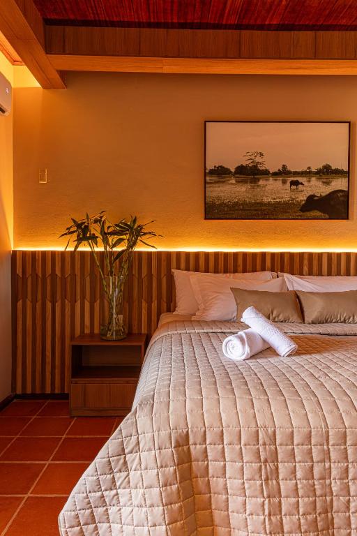 a bedroom with a large bed with a white comforter at Hotel Ilha do Marajó by Unna in Soure