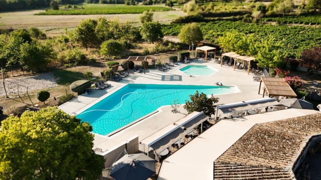 an overhead view of a swimming pool at a resort at ZEcamping 3 étoiles pet friendly avec piscine et pataugeoire in Les Assions