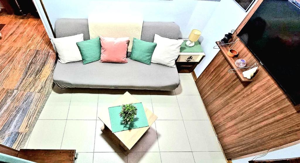 a living room with a couch with pillows on the floor at Apartment Cabin-Style in Belgrade