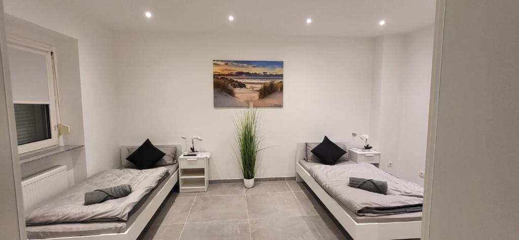 En eller flere senge i et værelse på Gästehaus Hagen 6 Betten, Parkplatz, Küche, WLAN Easybooking24