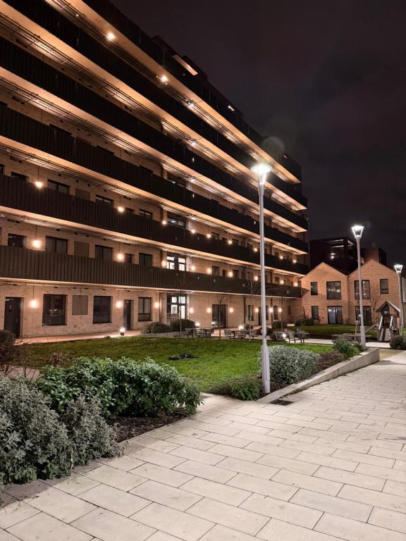 a large building with street lights in front of it at HRF Barking Apartments in Barking