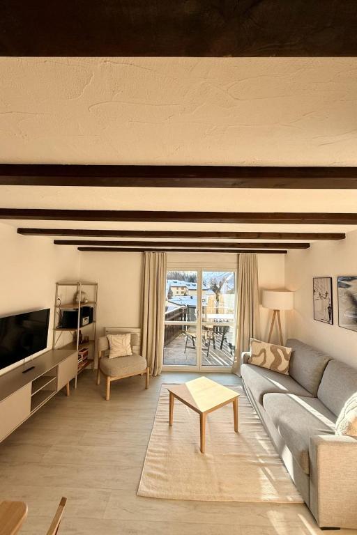 a living room with a couch and a tv at Apartment Residenza Chesa Margun 58-5 by Interhome in Surlej
