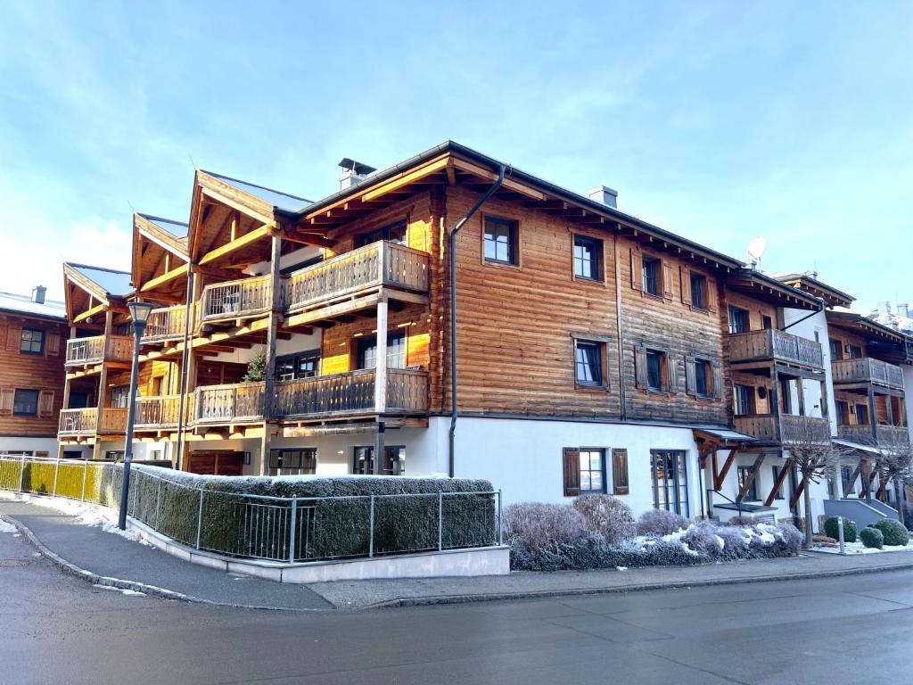 a large wooden building with balconies on a street at Apartment Mountain Resort C15 by Interhome in Kaprun