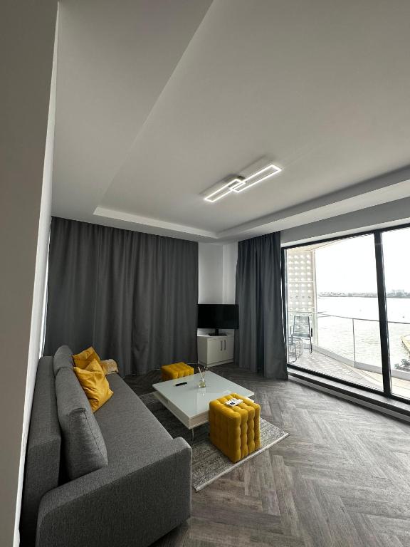 a living room with a couch and a table at Lake On Exclusive in Mamaia