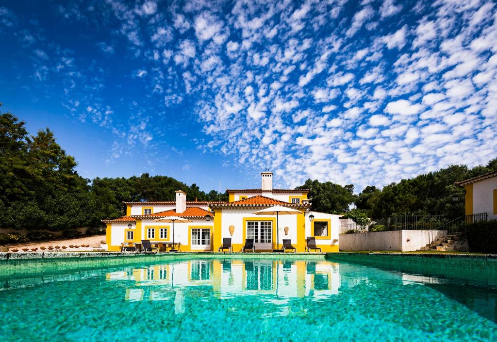 una casa con una piscina di fronte di Quinta do Pé Descalço - Country Guesthouse in Sintra a Sintra