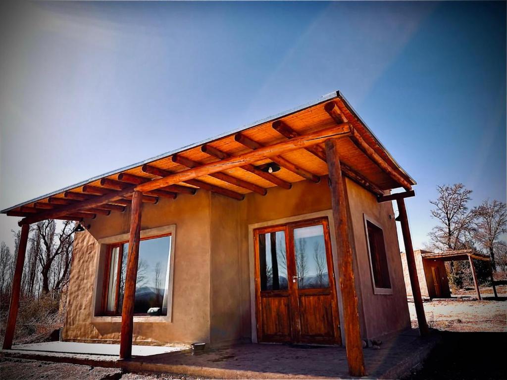 a small house is being constructed with a wooden roof at Capitan de Ansilta in Calingasta