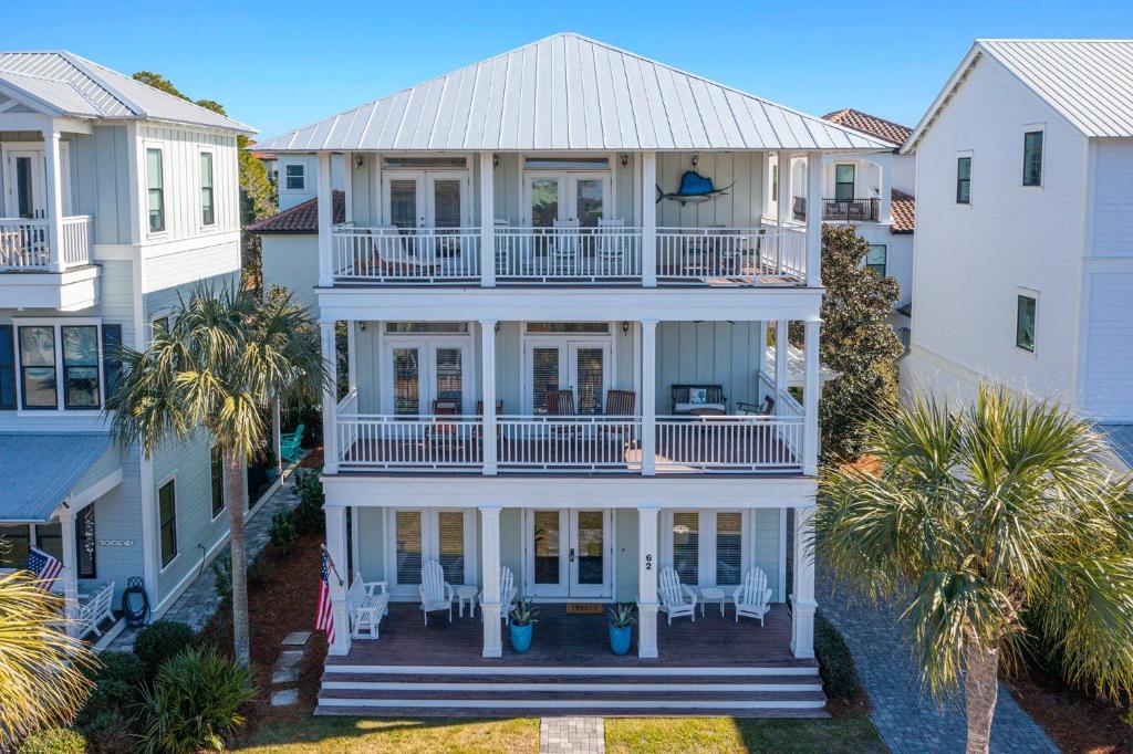 an aerial view of a white house with palm trees at Arrabella - Gulf Views with Deck & Community Pool in Santa Rosa Beach