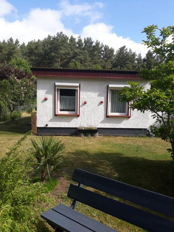 a white house with a bench in front of it at Haus in Malchow in Malchow