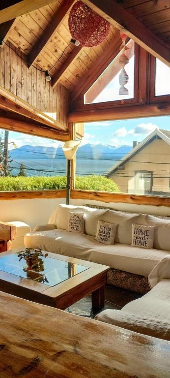 a living room with a couch and a glass table at Bariloche Hostel in San Carlos de Bariloche