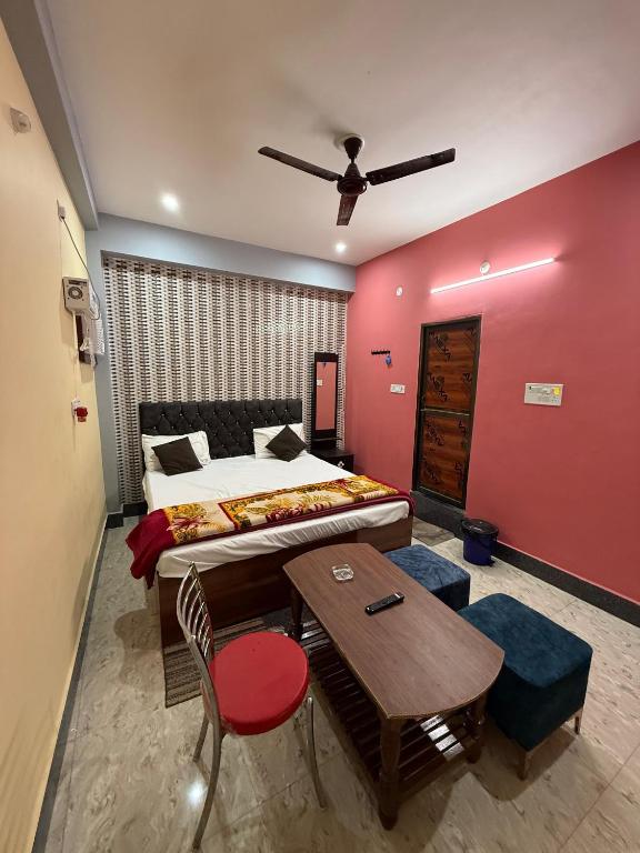 a hotel room with a bed and a table and a table at Hotel DK Inn sasaram in Sasarām