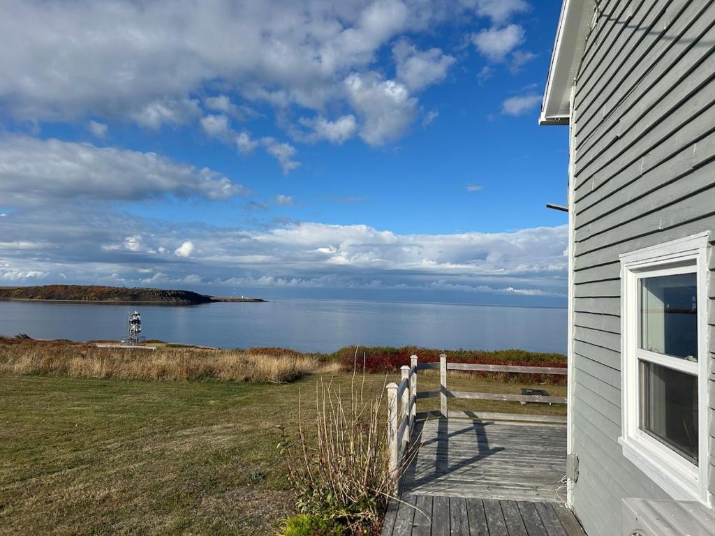 a house with a view of a body of water at Seaside Cottage 180 Views in Petit-Etang