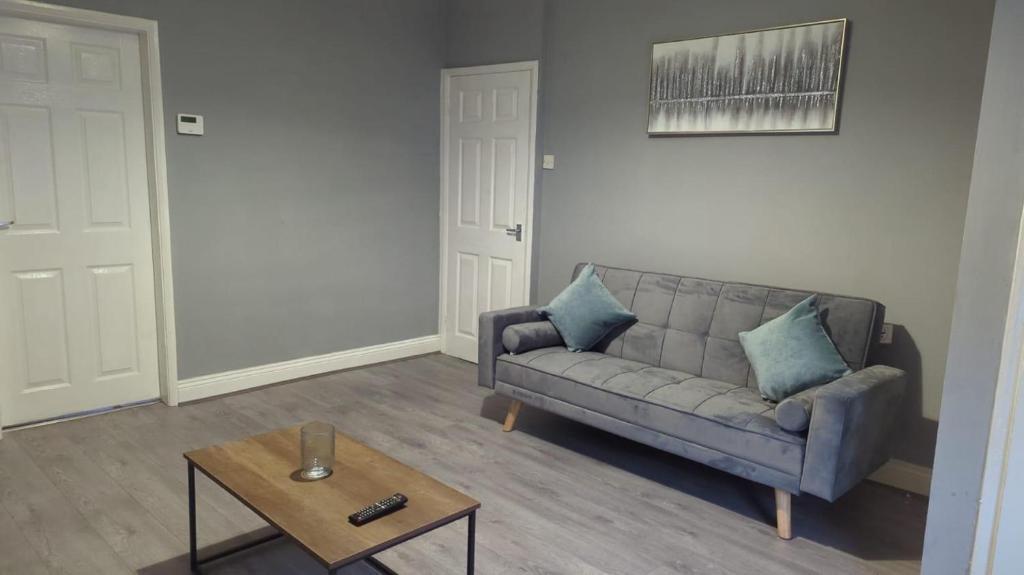 a living room with a couch and a coffee table at West Park One Bedroom in South Shields