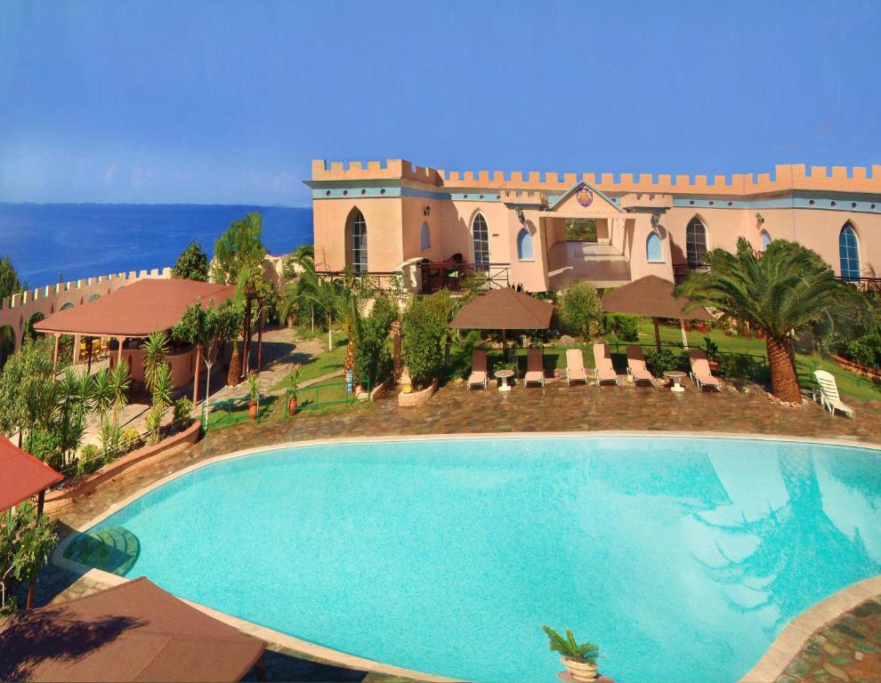 a large swimming pool in front of a building at Villa Pappas in Kanali