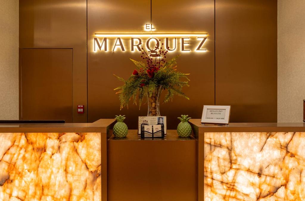 a lobby with a marquez sign on a wall at El Marquez Huancayo in Huancayo