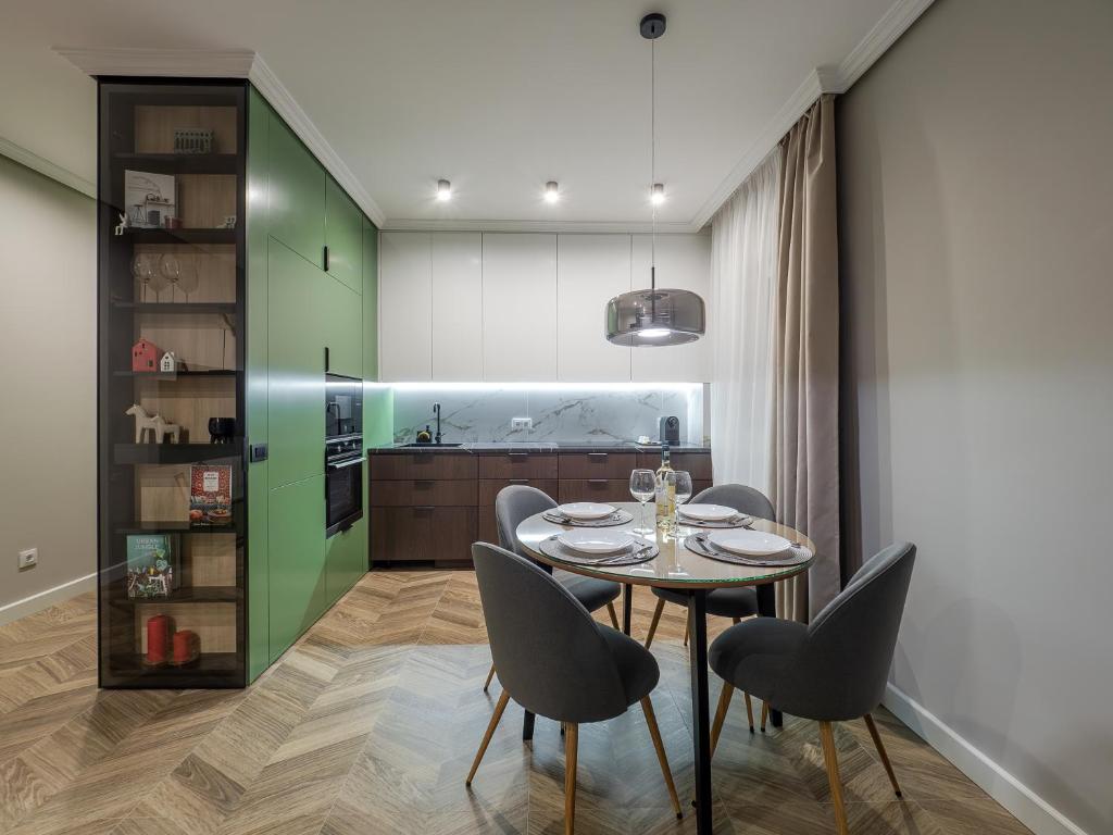 a kitchen and dining room with a table and chairs at Arhitect INN in Sibiu