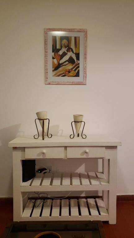 un tavolo consolle bianco con due vasi sopra di Urban 360 a Río Cuarto