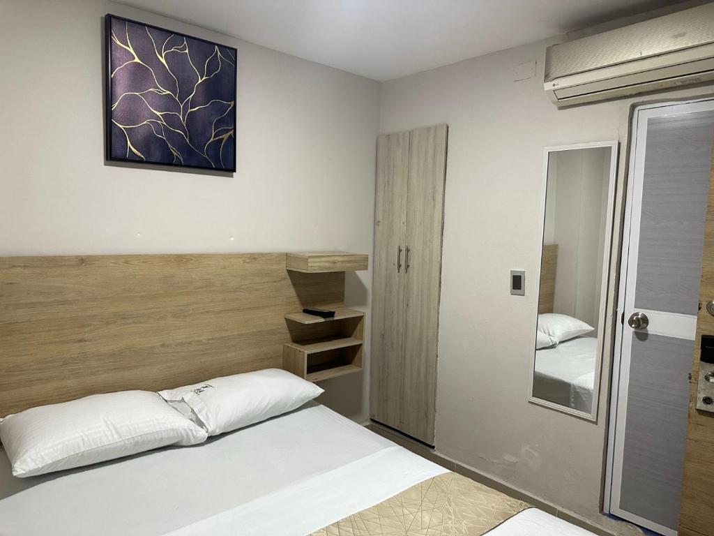 En eller flere senge i et værelse på Hospedaje GRAND H Rodadero & Suite