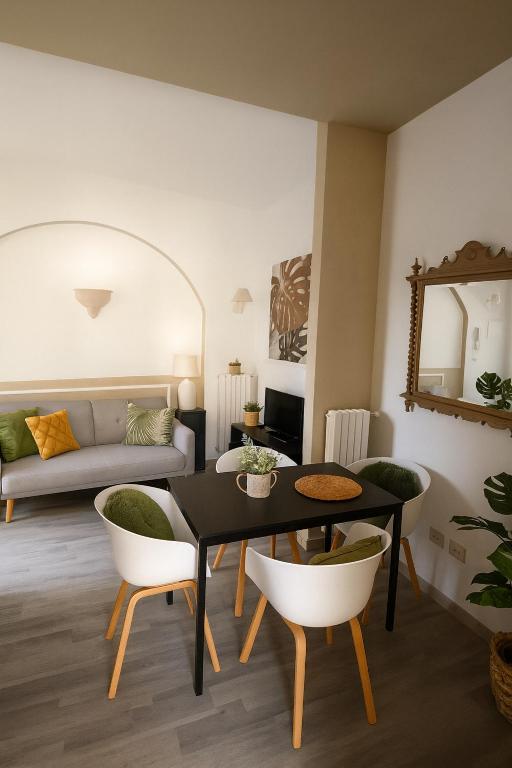a living room with a table and chairs and a couch at leuca bis house in Lecce