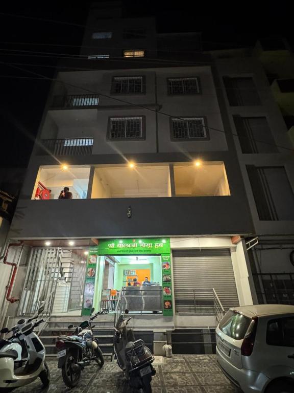 a building with motorcycles parked in front of it at Mahayaatri Niwas in Kolhapur