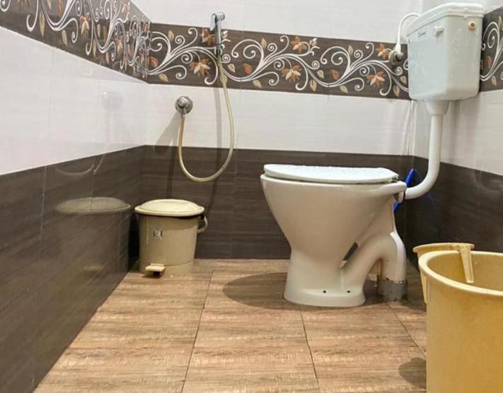 a bathroom with a white toilet in a room at The Dreams sea view in Puducherry