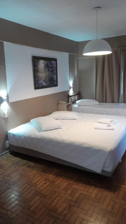 Ένα ή περισσότερα κρεβάτια σε δωμάτιο στο Nuevo Hotel