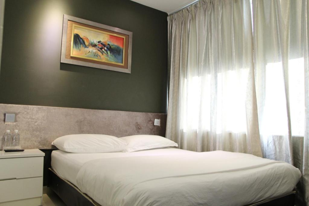 Postel nebo postele na pokoji v ubytování M Design Hotel @ Seri Kembangan