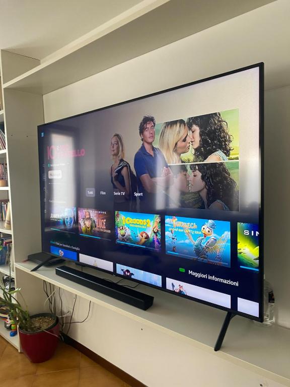 a large flat screen tv on a wall at Attico in centro in Udine