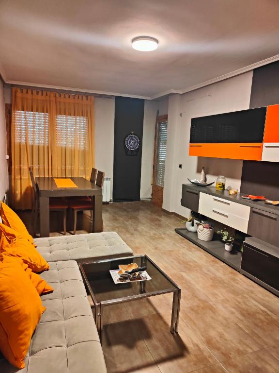 a living room with a couch and a table at Nuria's home in Calanda