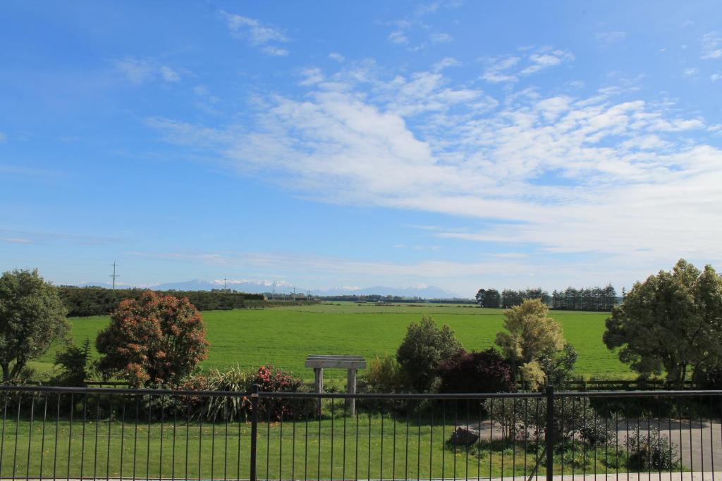 a view of a field behind a fence at Riverfields in Ashburton