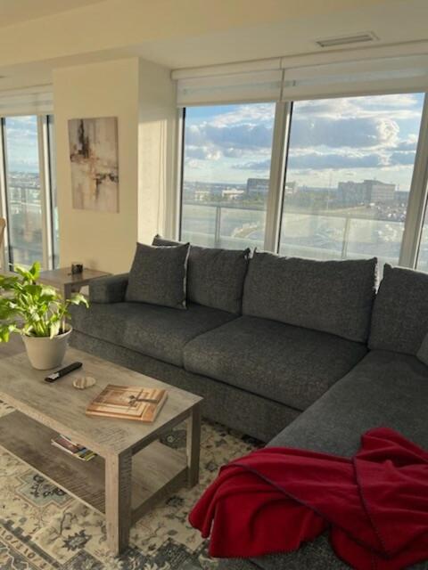 a living room with a couch and a table at Modern Private Room with Ensuite in Vaughan