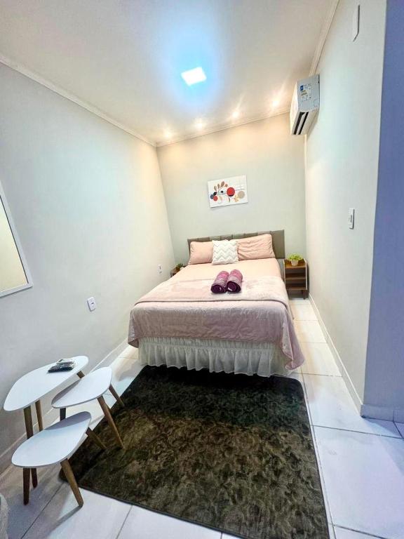 a bedroom with a bed and a table and chairs at PNZ Loft 2 in Petrolina
