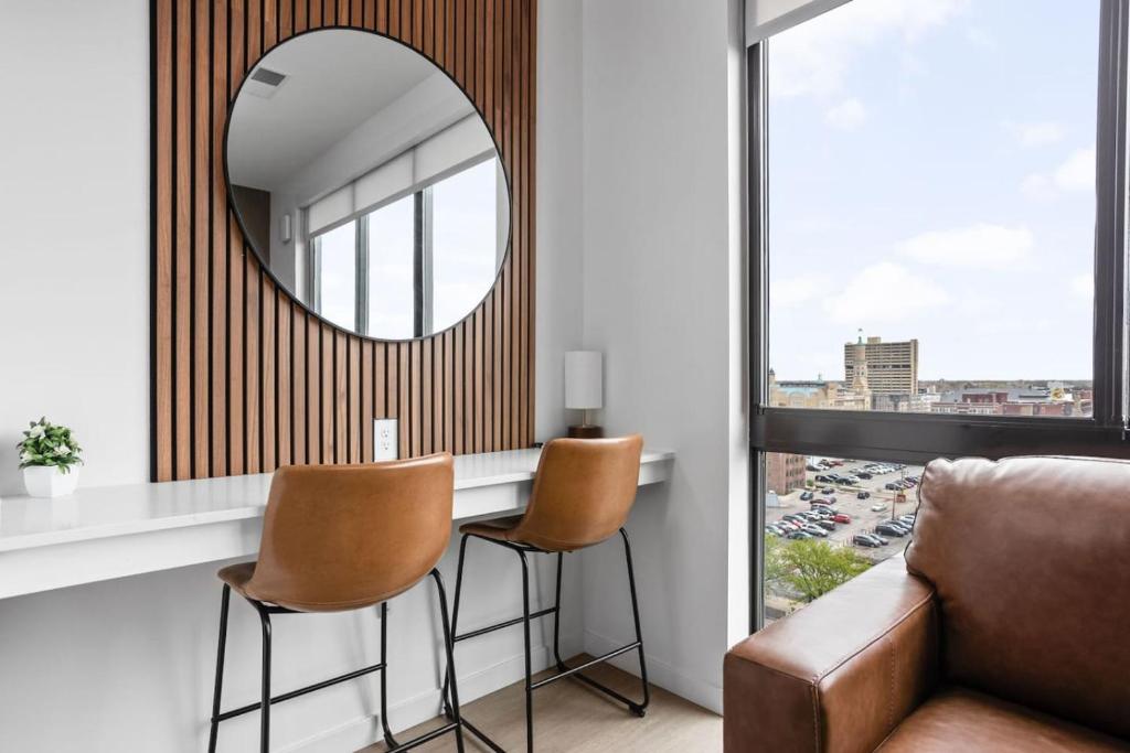- un miroir dans le salon avec un canapé et des chaises dans l'établissement Luxury Downtown High-Rise Condo with Pool, Gym, Parking, à Indianapolis